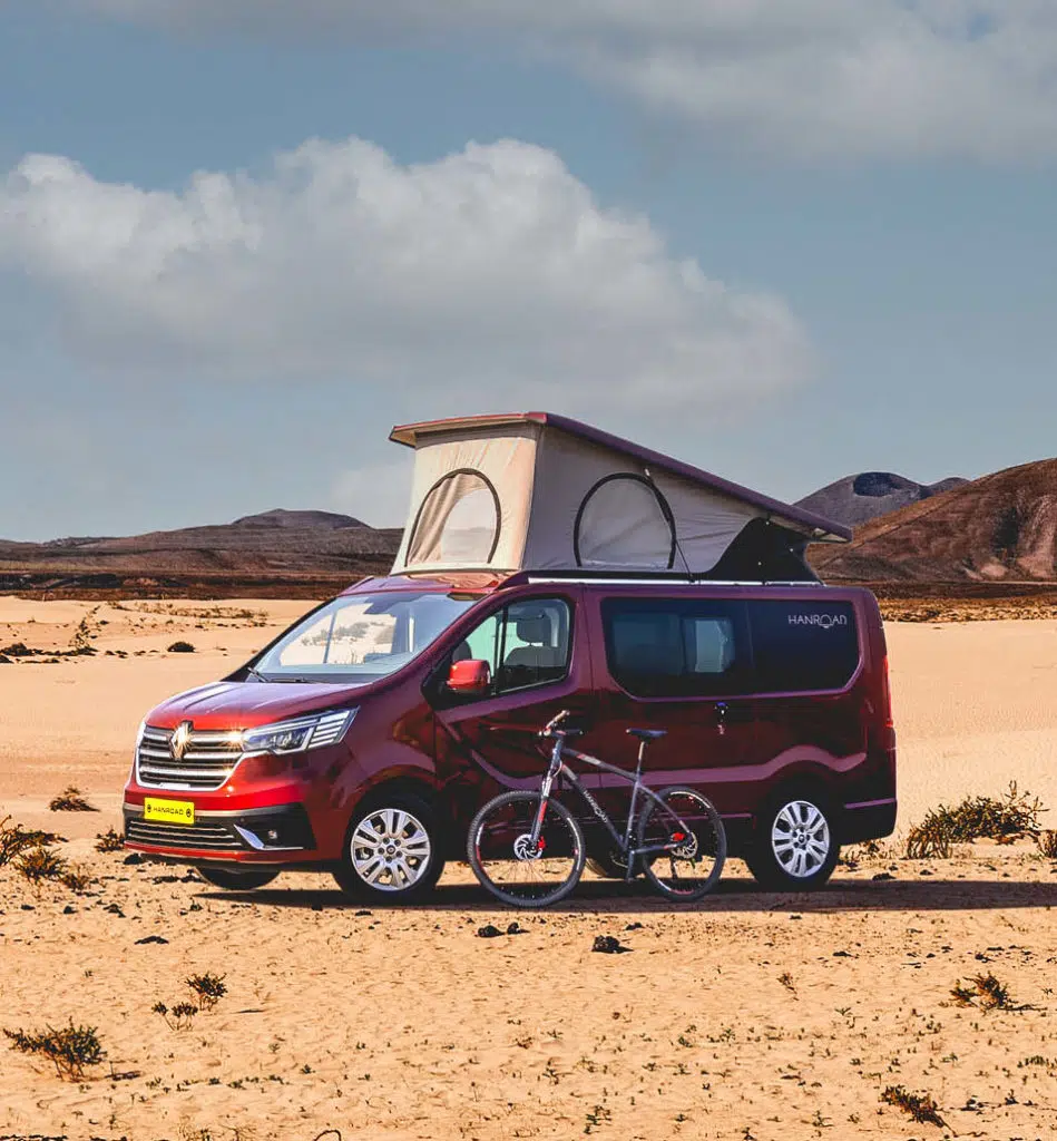 van aménagé rouge hanroad avec le toit relevé dans le désert
