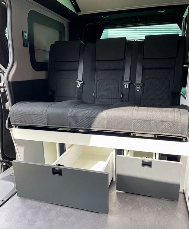 Van aménagé : Banquette fixe avec les deux tiroirs ouverts.